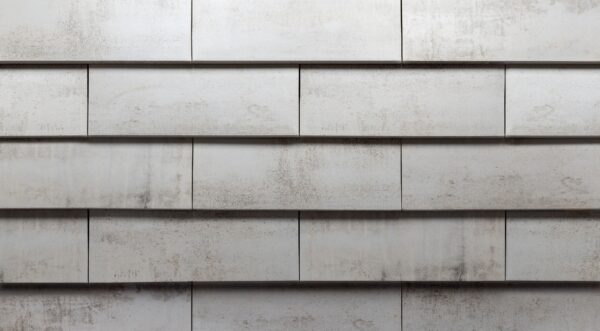 Tagsten_Vestfold - Klinker Made in Germany Row of light gray concrete blocks with vertical joints and subtle weathering creating a smooth wall surface.